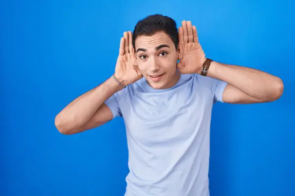 Young Hispanic Man Standing Blue Background Trying Hear Both Hands — Stock Photo, Image