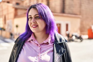 Young beautiful plus size woman smiling confident looking to the side at street