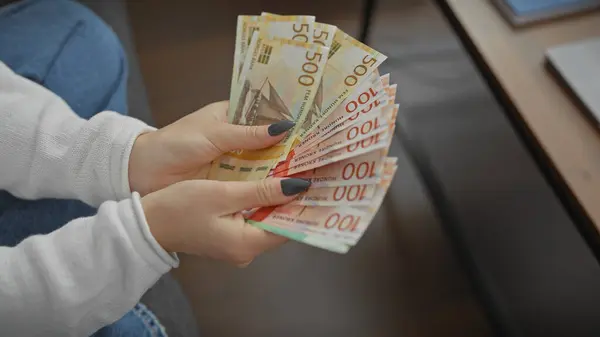 Young Caucasian Woman Counts Norwegian Kroner Money Indoors Portraying Wealth — Stock Photo, Image