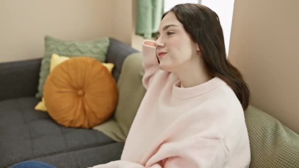 Relaxed Young Woman Pink Sweater Enjoys Comfort Gray Sofa Cozy — Stock Video