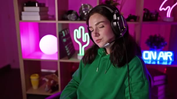 Young Caucasian Woman Wearing Headphones Neon Lit Gaming Room Night — Stock Video