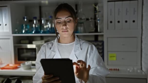 Hispanic Woman Scientist Examining Data Tablet Laboratory Indoor Setting — Stock Video