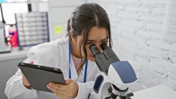 Eine Fokussierte Hispanische Wissenschaftlerin Untersucht Proben Mit Einem Mikroskop Einem — Stockvideo
