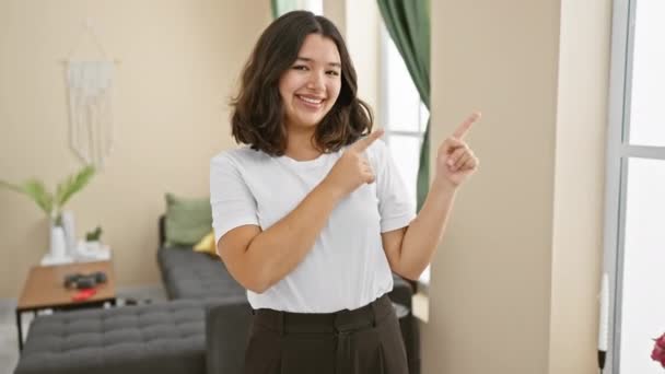Cheerful Young Hispanic Woman Standing Home Confidently Pointing Smiling Side — Stock Video