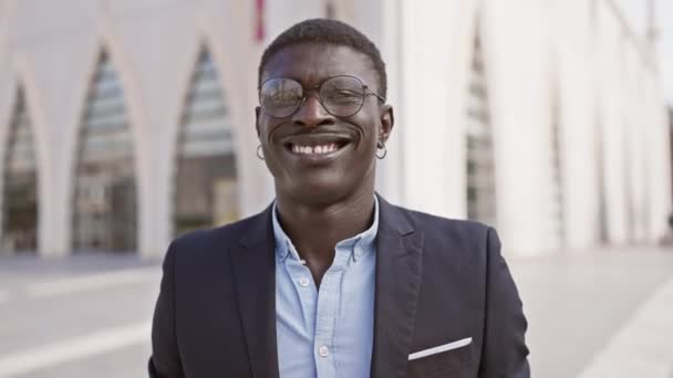 Hombre Africano Sonriente Traje Pie Calle Ciudad Con Arquitectura Moderna — Vídeo de stock