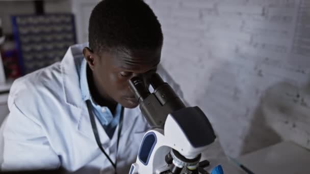 Svart Man Labbrock Använder Ett Mikroskop Ett Laboratorium Leende Ramarna — Stockvideo