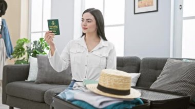 Neşeli, genç İspanyol bir kadın, parlak bir kazanan, pasaport zaferini evde kutluyor. Çekici bir gülümseme ve muzaffer bir ifadeyle, bu başarılı güzellik onun ellerinde eğlenceli bir zafer kazanıyor..