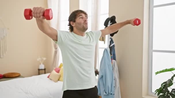 Young Man Exercises Dumbbells His Bright Bedroom Illustrating Healthy Active — Stock Video