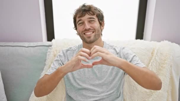 Ein Verliebter Junger Mann Sitzt Gemütlich Auf Seinem Wohnzimmersofa Und — Stockvideo