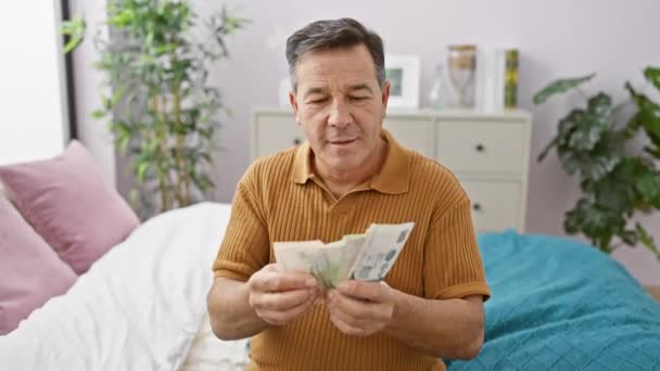 Mature Man Counting Singapore Dollars Cozy Bedroom Portraying Financial Planning — Αρχείο Βίντεο