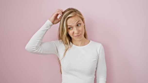Uncertain Young Blonde Woman Pensively Stands Pink Background Doubtfully Thinking — Stock Video