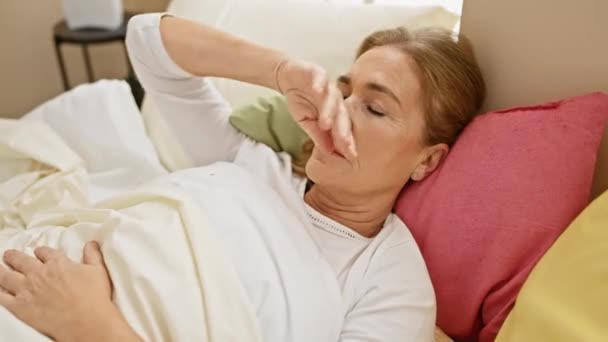 Mature Woman Seems Unwell She Rests Bedroom Expressing Discomfort While — Stock Video