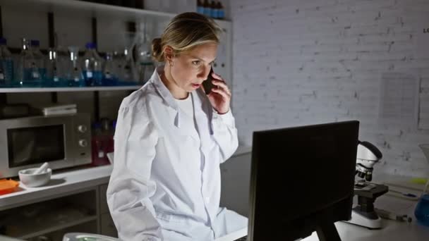 Young Woman Scientist White Lab Coat Using Computer Talking Phone — Stock Video