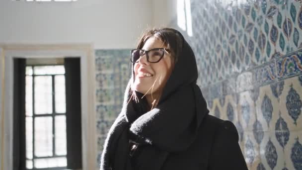 Mujer Sonriente Con Gafas Iluminada Por Luz Del Sol Dentro — Vídeos de Stock