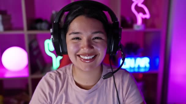 Smiling Hispanic Woman Headphones Neon Lit Gaming Room Night — Stock Video