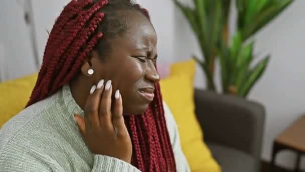 Bekymrad Afrikansk Kvinna Med Flätor Som Vidrör Kinden Smärta Inomhus — Stockvideo