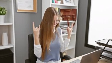 Ofisi sallayan, sarışın iş adamı bombası içindeki heavy metal yıldızını serbest bıraktı, iş yerinde kendini ifade eden elleri rock sembolü gibi parladı.