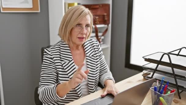 Cheerful Mature Woman Celebrates Success Modern Office Reflecting Achievement Joy — Stock Video