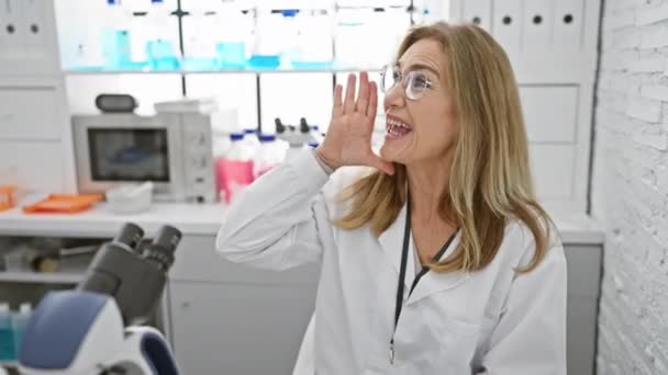 Furiosa Mujer Rubia Mediana Edad Científica Sentada Laboratorio Gritando Voz — Vídeos de Stock