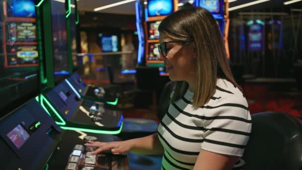 Smiling Young Woman Glasses Playing Slot Machines Vibrant Casino — Stock Video