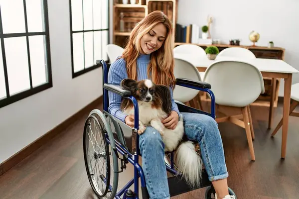 Young Caucasian Woman Sitting Wheelchair Touching Dog Home — Fotografia de Stock