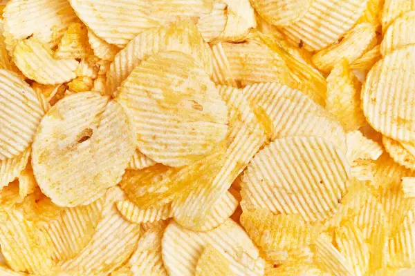 Close Rippled Potato Chips Showcasing Textured Surface Golden Yellow Color — Stock Photo, Image