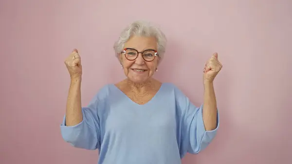 快乐的老年妇女 灰白的头发 与粉红的背景隔离在一起庆祝胜利 — 图库照片