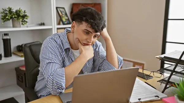 Young Man Sits Thinking His Laptop Modern Office Surrounded Paperwork — Stock Photo, Image