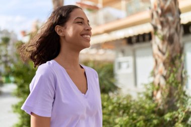 Young african american woman smiling confident looking to the side at street