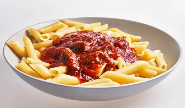 Plate Penne Pasta Topped Rich Tomato Sauce Serves Appetizing Italian — Stock Photo, Image
