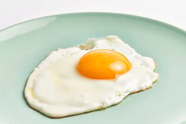 Close Freshly Fried Egg Runny Yolk Pale Green Plate Isolated — Stock Photo, Image