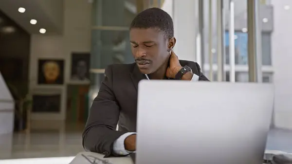 Professional African American Man Experiences Neck Pain While Working Laptop — Stock Photo, Image