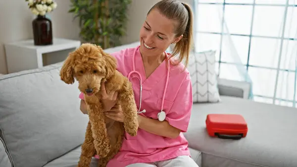 Young caucasian woman with dog veterinarian smiling confident holding dog at veterinary clinic