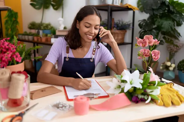Young African American Woman Florist Talking Smartphone Writing Document Flower — Stockfoto