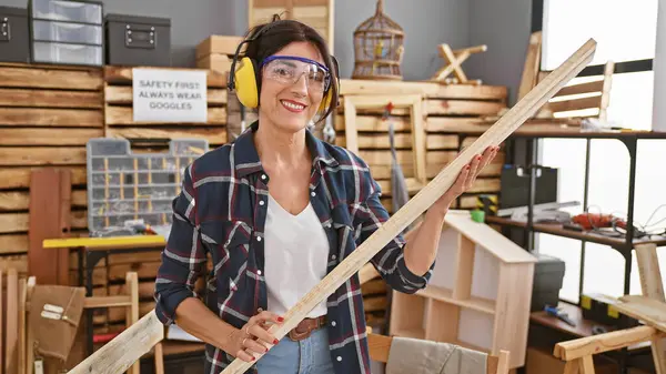 Smiling Woman Safety Gear Holding Lumber Bright Woodworking Workshop — Stock Photo, Image