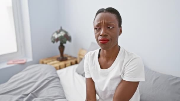 神经质的非洲裔美国女人 一个多疑 皱着眉头 躺在床上面对问题的女人 消极的人在卧室里烦躁不安 — 图库视频影像