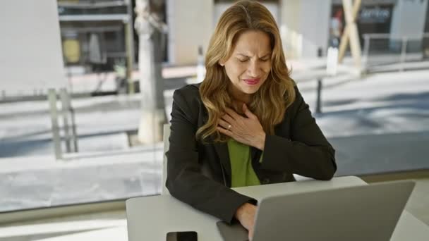 一个惊慌失措的女人在工作时感到不舒服 在办公室里带着痛苦的表情紧紧抓住她的胸口 — 图库视频影像