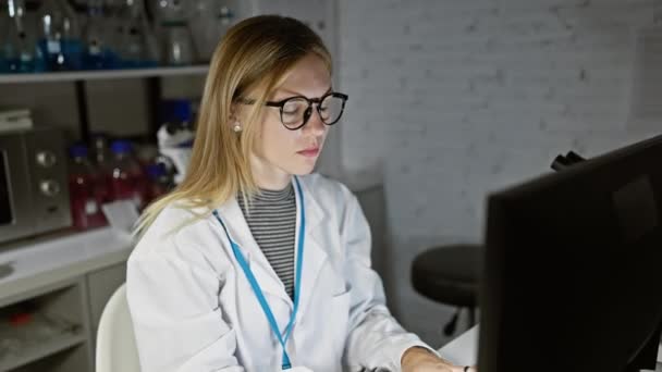 Worried Young Woman White Lab Coat Examines Data Computer Screen — Stock Video