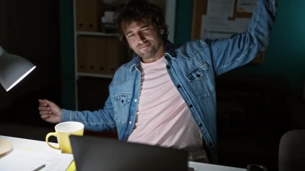 Hispanic Man Stretching Tiredly Office Night Next Coffee Laptop — Stock Video