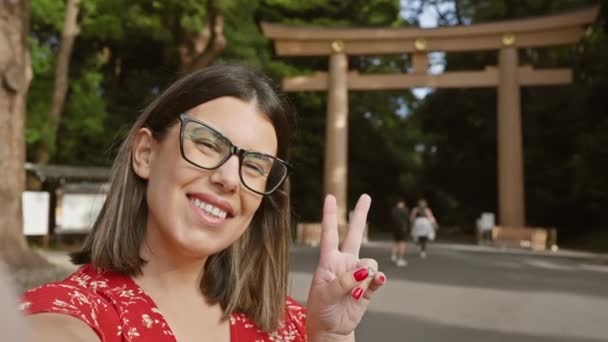快乐而美丽的他的惊慌失措的女人 戴着眼镜 开心地拍了一张自信的自拍照片 微笑着在庙宇 东京的文化圣地 捕捉了她快乐的时刻 — 图库视频影像
