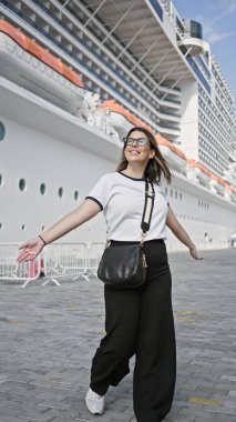 A joyful young woman embarks on a luxury cruise trip, evoking leisure and travel at sea. clipart