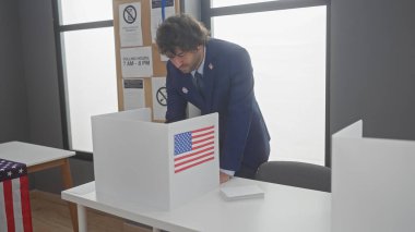 Hispanic man voting in american election, indoor with us flags clipart