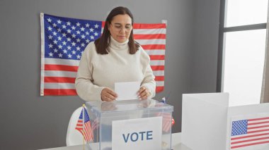 Hispanic woman voting in a usa electoral room with an american flag in the background clipart