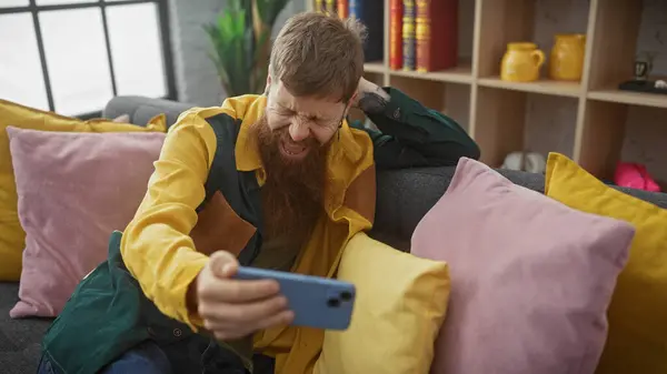 Redhead Beard Man Colorful Interior Laughing While Looking Smartphone — Stock Photo, Image