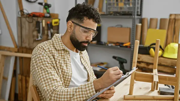 Handsome Hispanic Carpenter Beard Takes Notes Well Equipped Woodworking Workshop — Stock Photo, Image