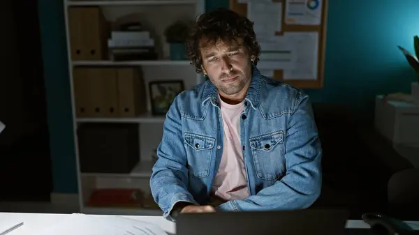 Handsome Hispanic Man Curly Hair Wearing Denim Jacket Sitting Pensively — Stock Photo, Image