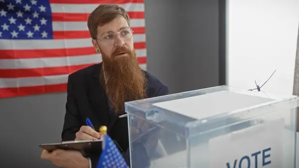 Bearded Man Glasses Taking Notes American Voting Station Flag Backdrop — Stock Photo, Image