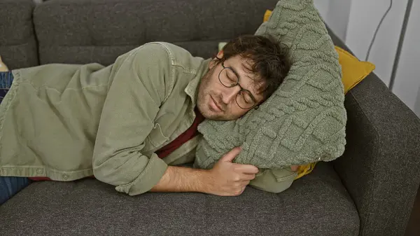 Young Man Glasses Sleeps Cozily Green Pillow Gray Couch Home — Stock Photo, Image
