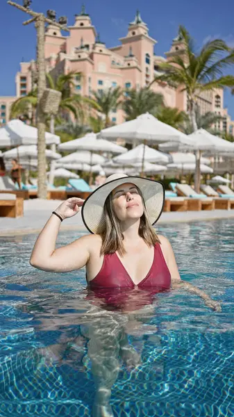 Content Woman Enjoying Sun Pool Luxury Resort Wearing Hat Swimwear — Stock Photo, Image