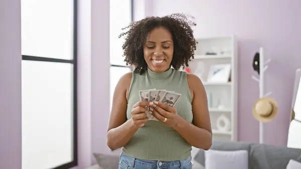 African american woman with money indoors